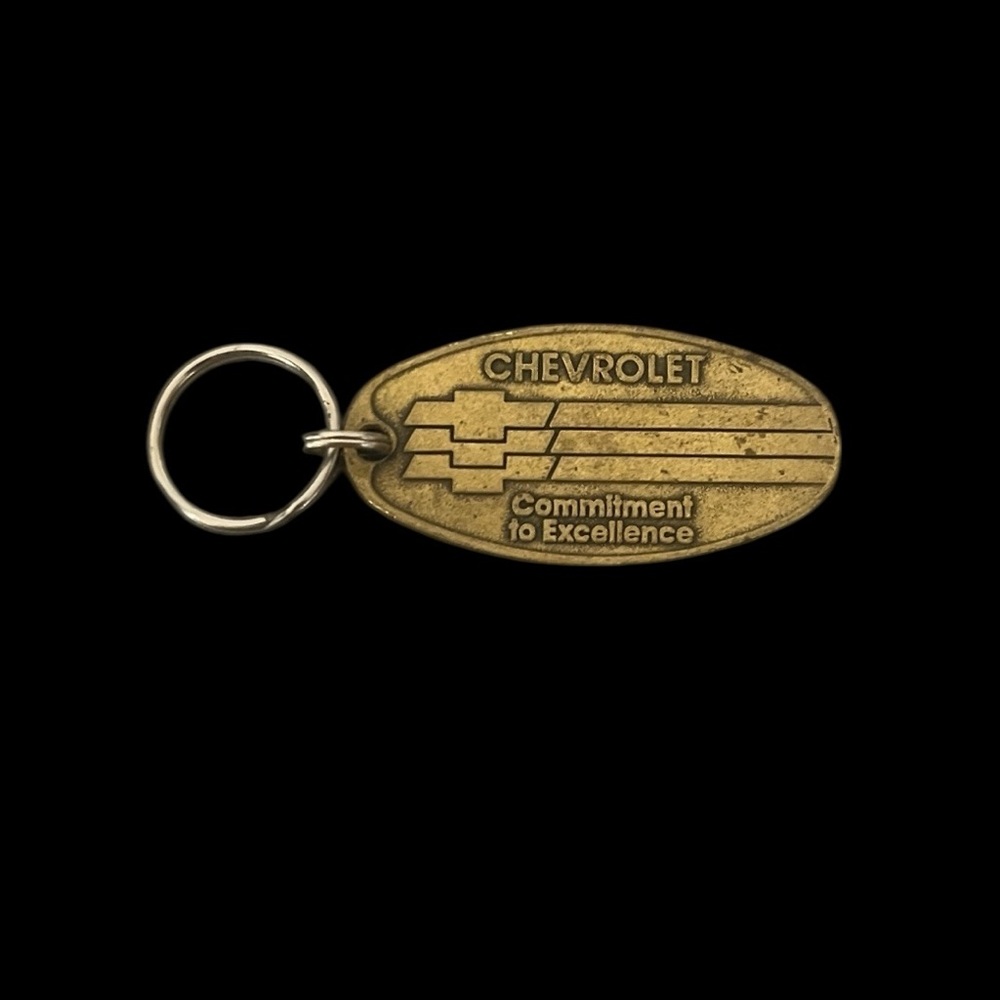 VTG Chevrolet Commitment To Excellence Brass Return Postage Key Chain Logo
